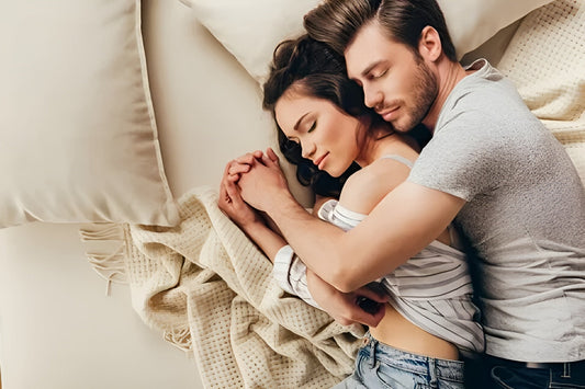 Happy couple cuddling on bed, symbolizing intimacy and connection boosted by Mosle Ayurvedic Lehyam for sexual energy and stamina.